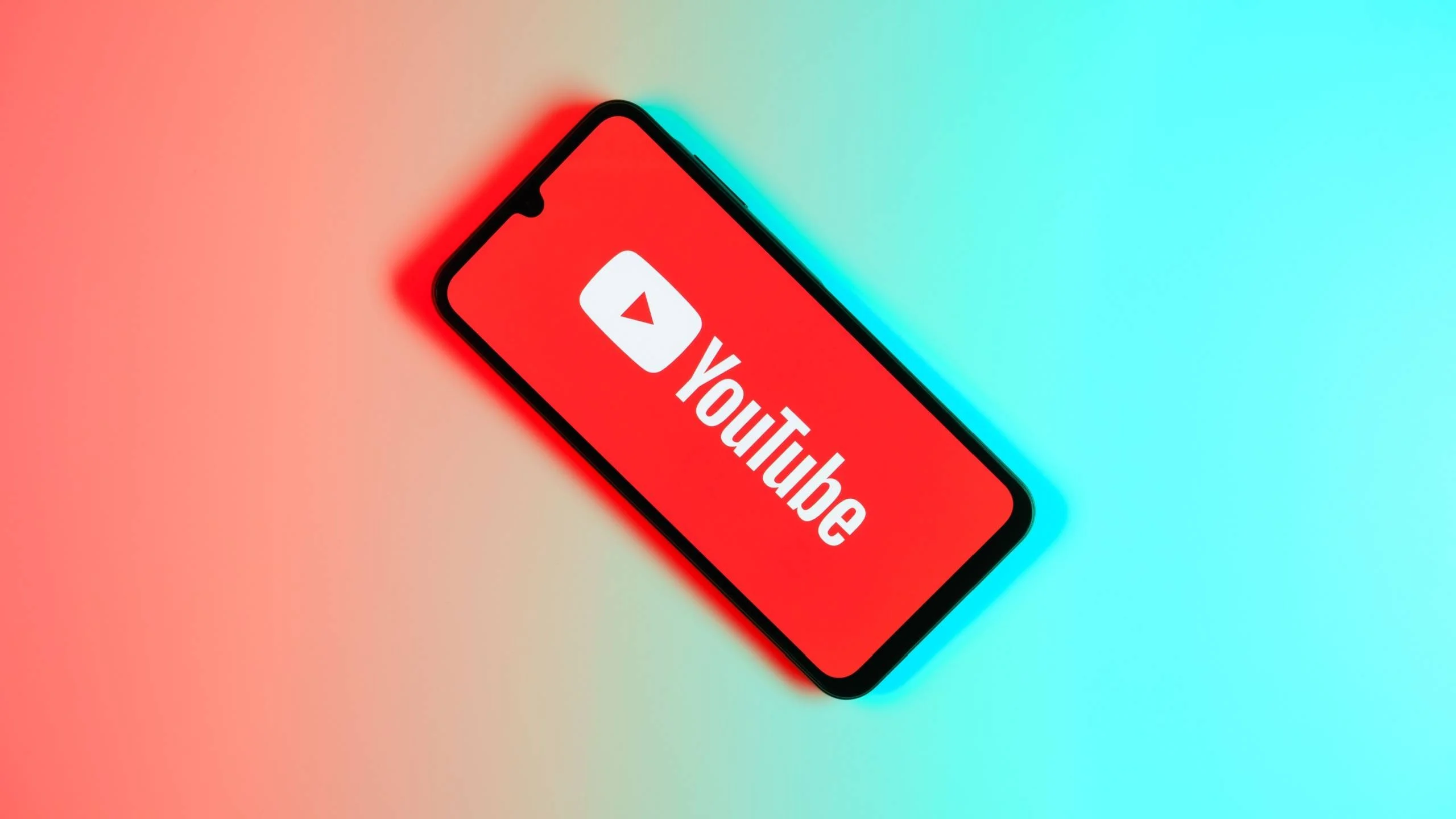 YouTube logo on a phone on top of gradient background